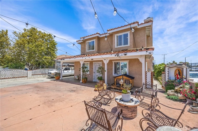 1709 S Townsend St, Santa Ana, CA 92704 - rear view of house with stucco siding and a tiled roof