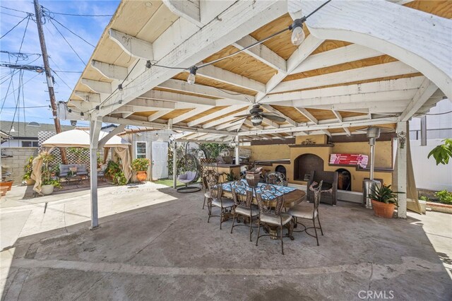 1709 S Townsend St, Santa Ana, CA 92704 - view of patio featuring a gazebo, outdoor dining space, an outdoor fireplace, and a ceiling fan