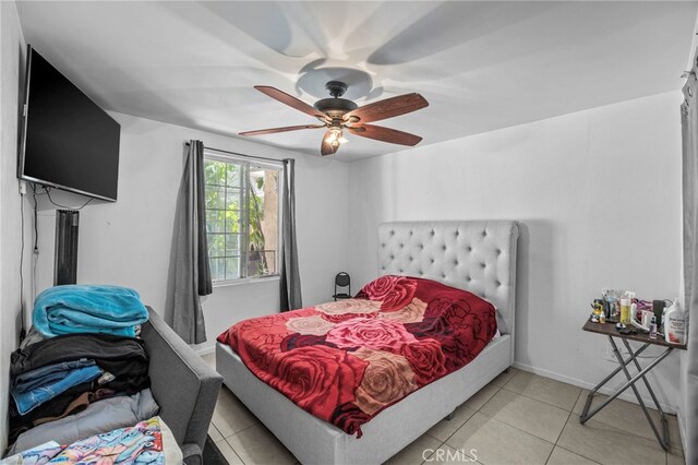 1709 S Townsend St, Santa Ana, CA 92704 - bedroom with light tile patterned floors, ceiling fan, and baseboards
