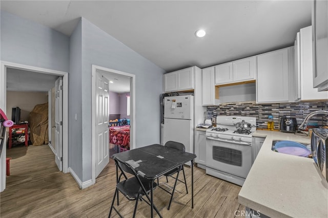 1709 S Townsend St, Santa Ana, CA 92704 - kitchen with white appliances, a sink, light wood-style flooring, backsplash, and light countertops