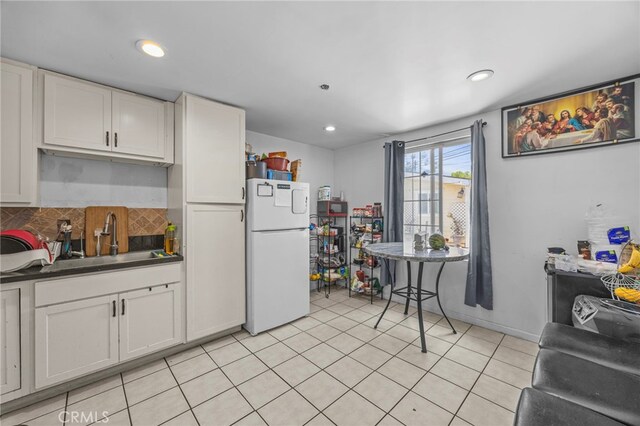 1709 S Townsend St, Santa Ana, CA 92704 - kitchen featuring freestanding refrigerator, a sink, white cabinetry, dark countertops, and recessed lighting
