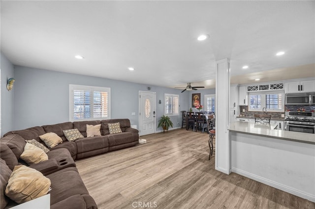 1709 S Townsend St, Santa Ana, CA 92704 - living room featuring light wood-style floors, ceiling fan, recessed lighting, and baseboards