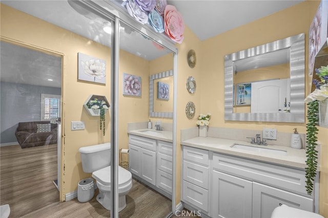 1709 S Townsend St, Santa Ana, CA 92704 - bathroom with wood finished floors, toilet, vanity, and baseboards
