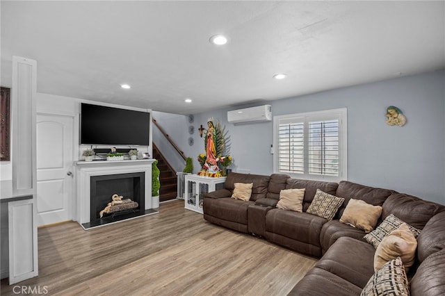1709 S Townsend St, Santa Ana, CA 92704 - living area featuring a wall unit AC, wood finished floors, recessed lighting, stairway, and a fireplace