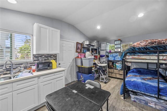1709 S Townsend St, Santa Ana, CA 92704 - bedroom featuring vaulted ceiling, a sink, light wood-style floors, and recessed lighting