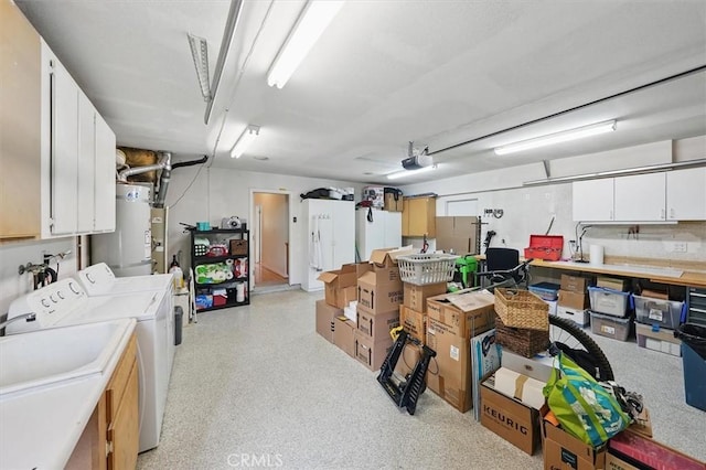28613 Apricot Pl, Valencia, CA 91390 - below grade area featuring washer and clothes dryer, a garage, water heater, and a sink