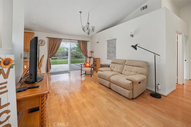 28613 Apricot Pl, Valencia, CA 91390 - living room featuring a chandelier, light wood finished floors, and vaulted ceiling