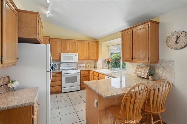 28613 Apricot Pl, Valencia, CA 91390 - kitchen featuring white appliances, a peninsula, a sink, decorative backsplash, and vaulted ceiling