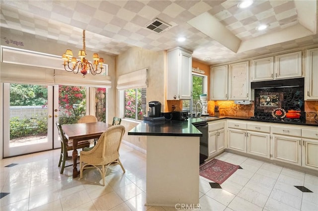 81 Via Barcaza, Coto De Caza, CA 92679 - kitchen with a chandelier, dark countertops, a sink, black appliances, and a peninsula