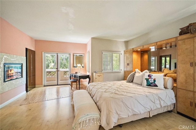 81 Via Barcaza, Coto De Caza, CA 92679 - bedroom featuring access to outside, wood finished floors, multiple windows, and a high end fireplace