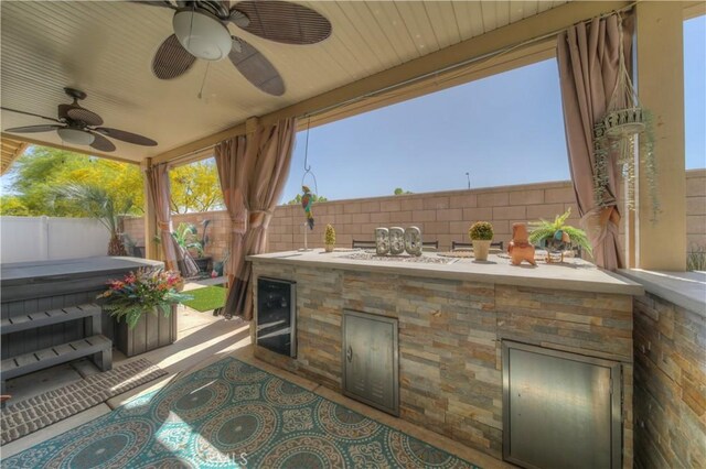 14663 Round Leaf Rd, Moreno Valley, CA 92555 - fenced backyard featuring a covered hot tub, ceiling fan, beverage cooler, and a patio