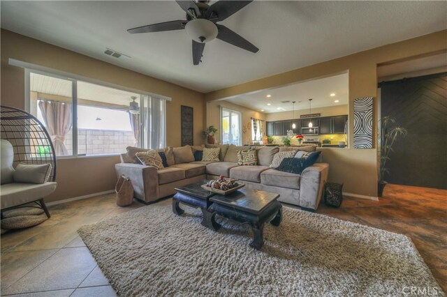 14663 Round Leaf Rd, Moreno Valley, CA 92555 - living room featuring baseboards, a ceiling fan, stone finish flooring, and recessed lighting