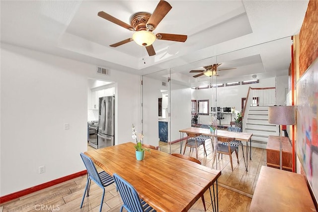 13023 Avenida Empresa, Riverside, CA 92503 - dining space featuring a raised ceiling, ceiling fan, and light wood-style flooring
