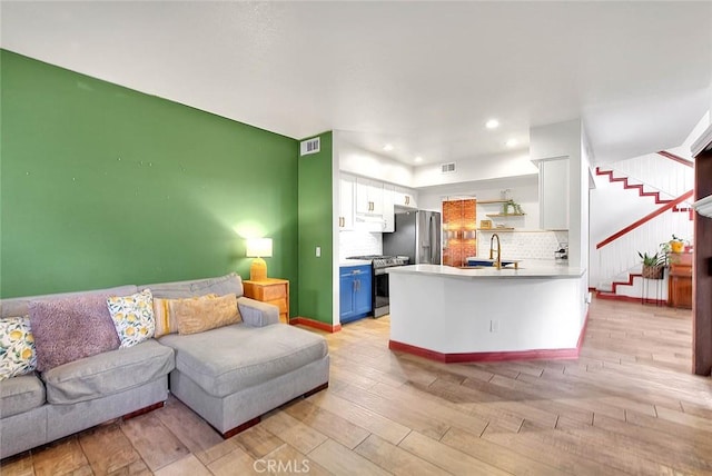 13023 Avenida Empresa, Riverside, CA 92503 - living area with light wood-style floors, stairway, and recessed lighting