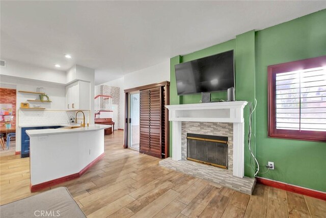 13023 Avenida Empresa, Riverside, CA 92503 - kitchen with a fireplace, light wood finished floors, open shelves, white cabinets, and open floor plan