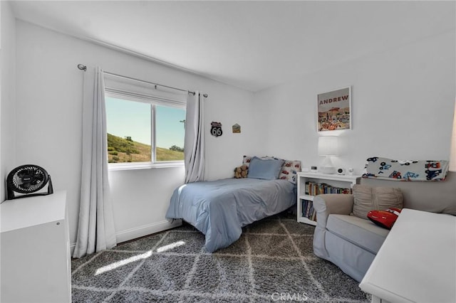 bedroom with carpet floors and baseboards