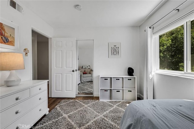bedroom featuring dark wood finished floors