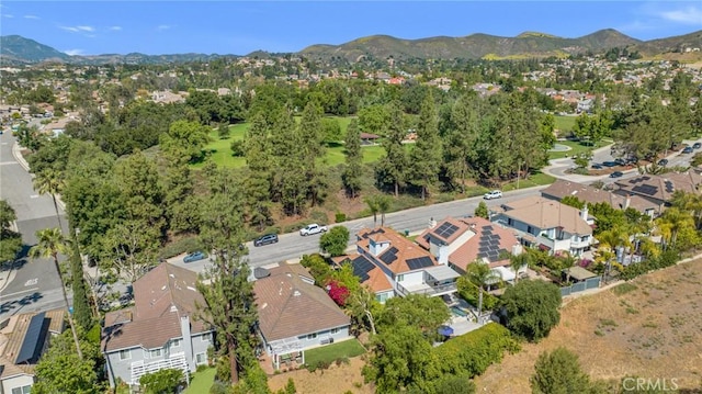 aerial view of property and surrounding area with nearby suburban area and a mountainous background