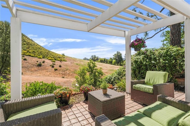 view of patio / terrace with an outdoor living space and a pergola