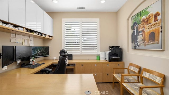 office with recessed lighting and light wood-style flooring