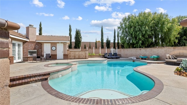 view of pool featuring a patio area, french doors, a fenced backyard, and a pool with connected hot tub