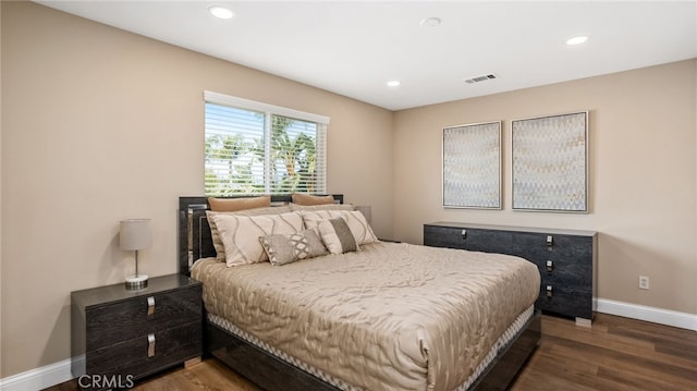bedroom featuring wood finished floors, baseboards, and recessed lighting