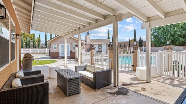 view of patio with fence, french doors, an outdoor structure, and outdoor lounge area