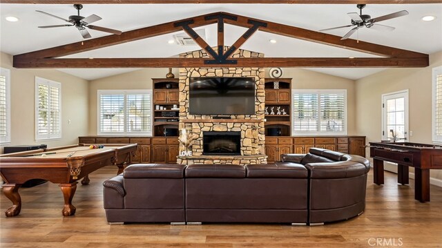 living room with light wood-style floors, a ceiling fan, recessed lighting, billiards table, and a stone fireplace