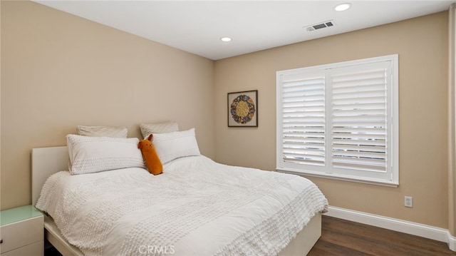 bedroom featuring baseboards, dark wood-style flooring, and recessed lighting