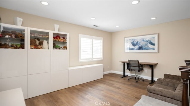 office space featuring recessed lighting, light wood finished floors, and baseboards