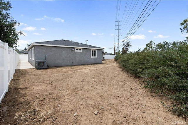 6018 William St, Riverside, CA 92504 - back of house with ac unit, a fenced backyard, and stucco siding