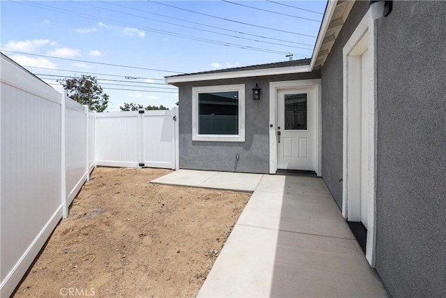6018 William St, Riverside, CA 92504 - property entrance with stucco siding, fence, and a patio