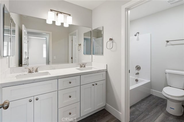 6018 William St, Riverside, CA 92504 - full bath with wood finished floors, toilet, double vanity, baseboards, and bathing tub / shower combination