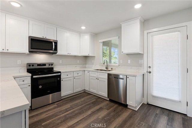 6018 William St, Riverside, CA 92504 - kitchen with appliances with stainless steel finishes, a sink, dark wood finished floors, white cabinets, and recessed lighting