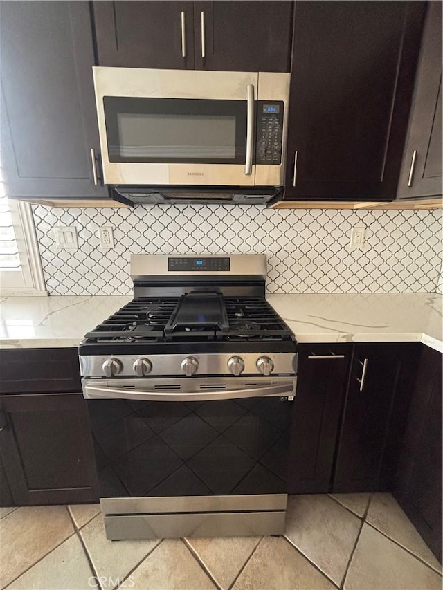 15986 Wilmington Rd, Chino Hills, CA 91709 - kitchen featuring appliances with stainless steel finishes, light tile patterned floors, backsplash, and light stone counters