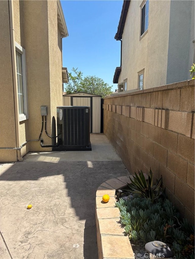 15986 Wilmington Rd, Chino Hills, CA 91709 - view of side of home with central AC unit, fence, a patio area, and stucco siding