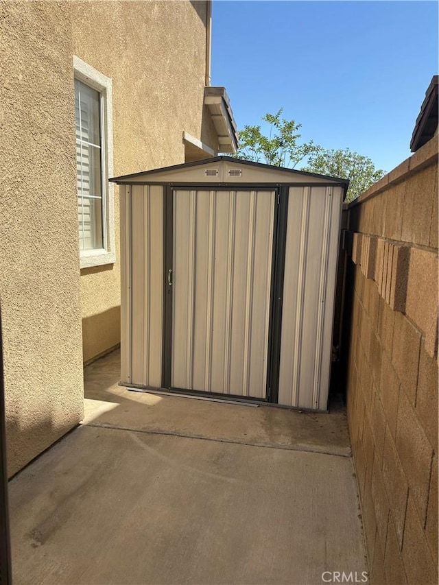 15986 Wilmington Rd, Chino Hills, CA 91709 - view of patio / terrace with a storage unit, an outdoor structure, and fence