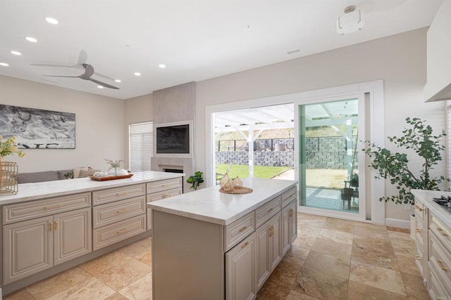 3044 Casmeg Way, El Cajon, CA 92019 - kitchen with light countertops, recessed lighting, a large fireplace, ceiling fan, and light stone finish floors