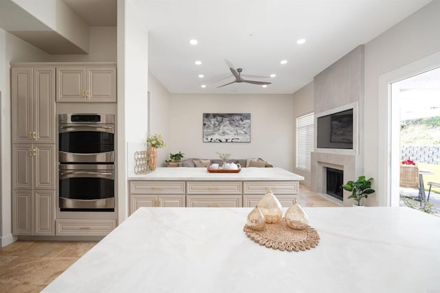 3044 Casmeg Way, El Cajon, CA 92019 - kitchen with stainless steel double oven, recessed lighting, open floor plan, ceiling fan, and a fireplace