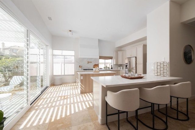 3044 Casmeg Way, El Cajon, CA 92019 - kitchen featuring stainless steel fridge, light countertops, a breakfast bar, a peninsula, and a center island