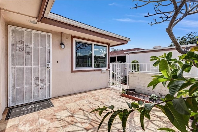 777 E Valley Blvd Unit 77, Alhambra, CA 91801 - property entrance featuring stucco siding, fence, a gate, and a patio