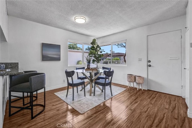 777 E Valley Blvd Unit 77, Alhambra, CA 91801 - dining area featuring wood finished floors, a textured ceiling, and baseboards