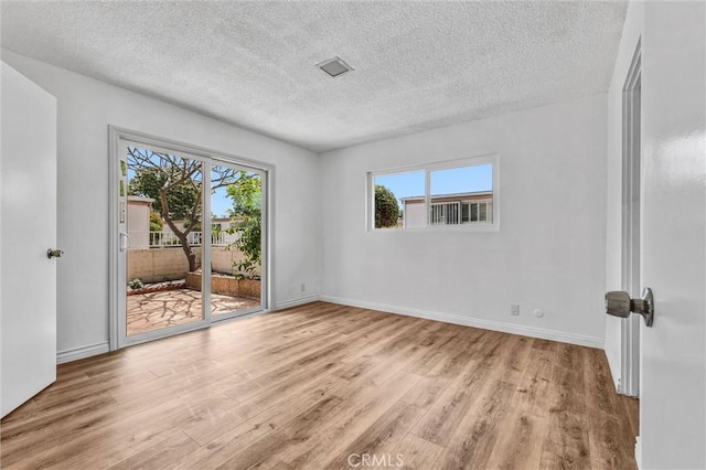 777 E Valley Blvd Unit 77, Alhambra, CA 91801 - unfurnished room featuring wood finished floors, healthy amount of natural light, a textured ceiling, and baseboards