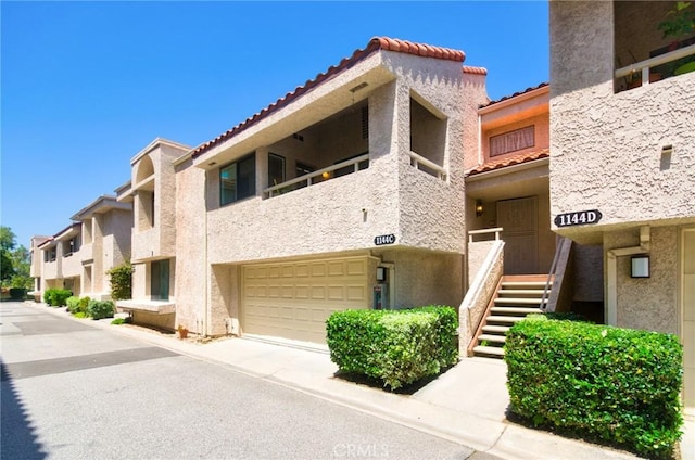 1144 Walnut Grove Ave Unit C, Rosemead, CA 91770 - view of property featuring an attached garage and driveway