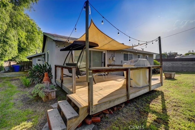back of property with a wooden deck and stucco siding