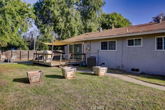 rear view of property featuring central AC unit, a wooden deck, crawl space, and stucco siding