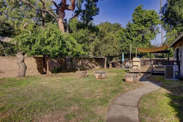 view of yard featuring cooling unit and a wooden deck