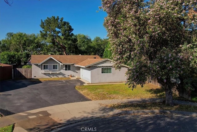 view of front of home featuring driveway, stucco siding, and an attached garage