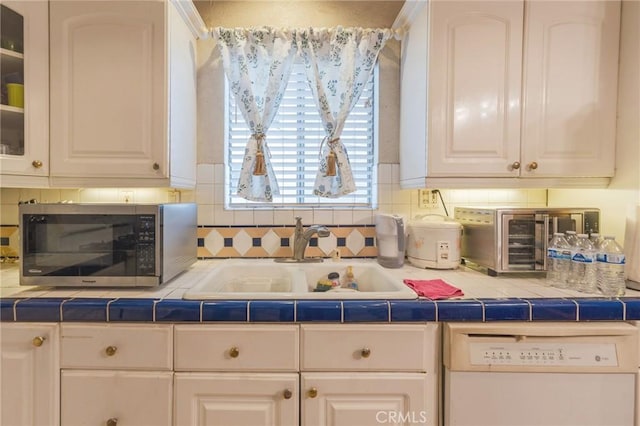 2613 E 221st St, Carson, CA 90810 - kitchen with stainless steel microwave, dishwasher, a sink, and white cabinets