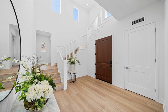 270 Maricopa, Irvine, CA 92618 - entryway with light wood-type flooring, stairs, a high ceiling, and baseboards